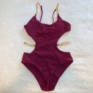 one piece open back bathing suite with detachable gold chain band